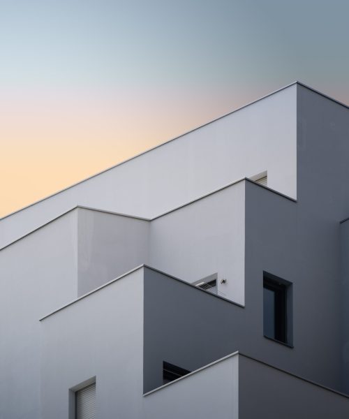 A vertical low angle shot of a white concrete building captured in Massy, France